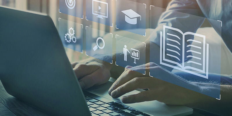 Person using laptop with digital icons